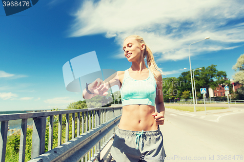 Image of smiling young woman running outdoors