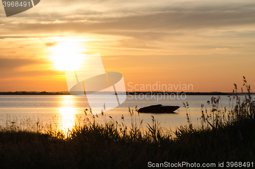 Image of Boat silhouette by sunset