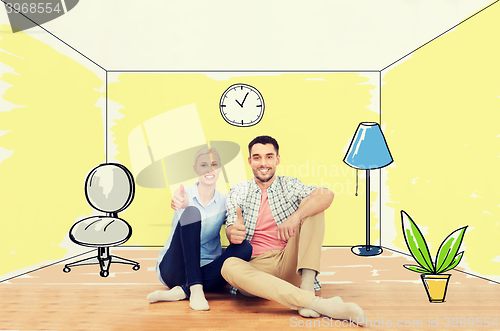 Image of happy couple showing thumbs up at new home