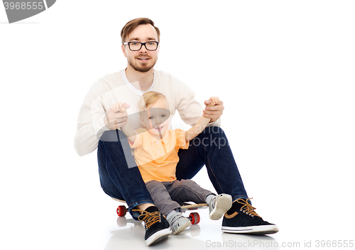 Image of happy father and little son on skateboard
