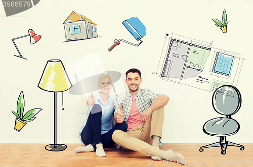 Image of happy couple showing thumbs up at new home