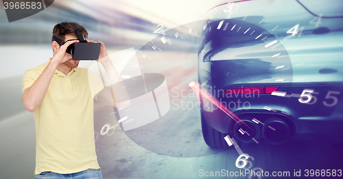 Image of man in virtual reality headset and car racing game