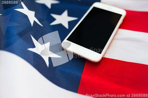 Image of close up of smartphone on american flag