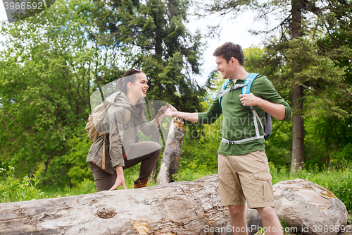 Image of smiling couple with backpacks hiking