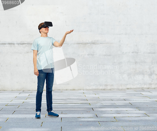 Image of happy man in virtual reality headset or 3d glasses