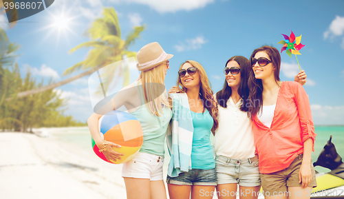 Image of smiling girls in shades having fun on the beach