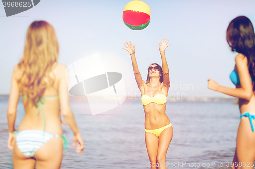 Image of girls with ball on the beach