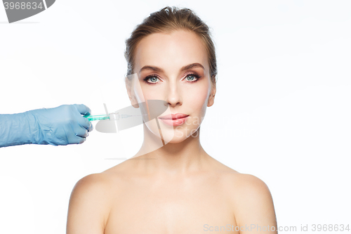 Image of woman face and hand with syringe making injection