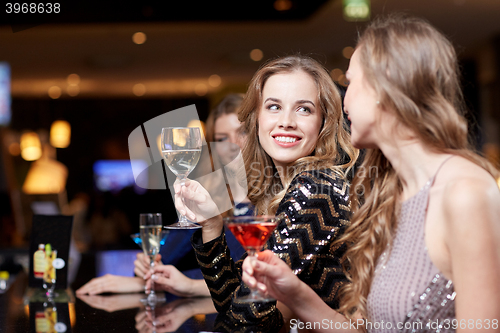 Image of happy women with drinks at night club