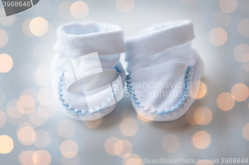 Image of close up of white baby bootees for newborn boy