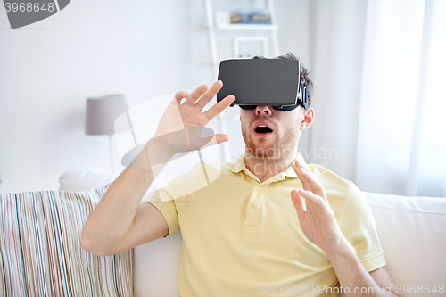 Image of young man in virtual reality headset or 3d glasses