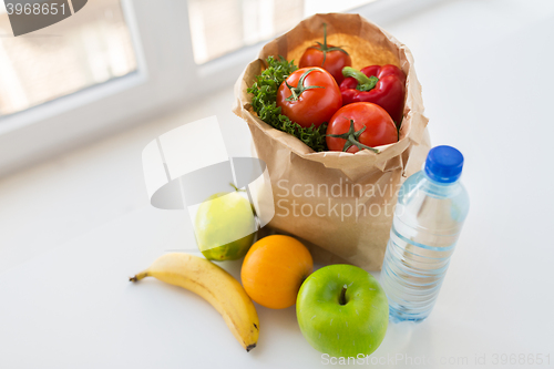 Image of basket of vegetable food and water at kitchen
