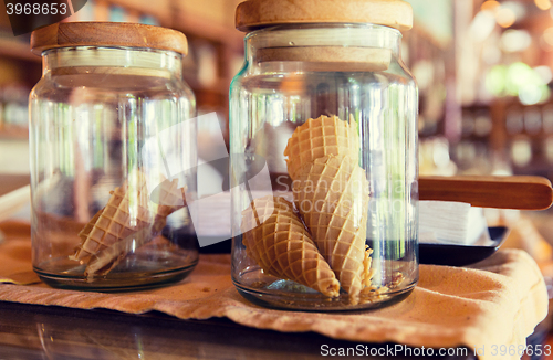 Image of close up of jars with waffle cones at restaurant