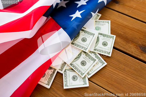 Image of close up of american flag and dollar cash money