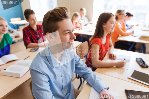 Image of group of students with notebooks at school lesson