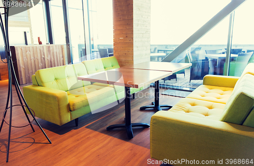 Image of restaurant interior with table and sofas