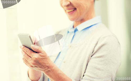 Image of close up of senior woman with smartphone texting