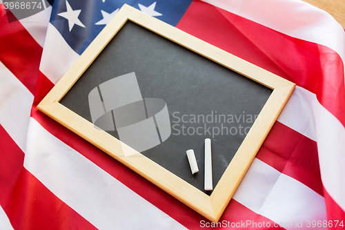 Image of close up of school blackboard on american flag