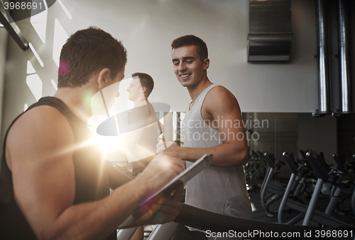 Image of men exercising on treadmill in gym