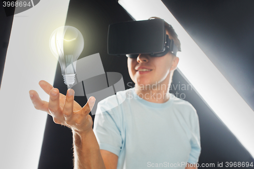 Image of happy man in virtual reality headset or 3d glasses