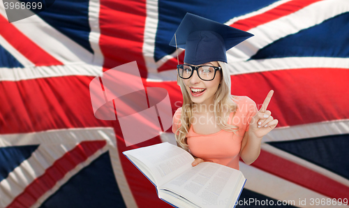 Image of student woman in mortarboard over english flag