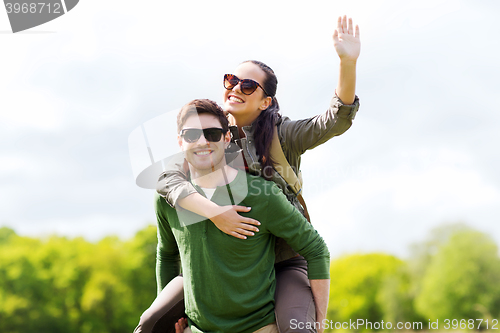 Image of happy couple with backpacks having fun outdoors