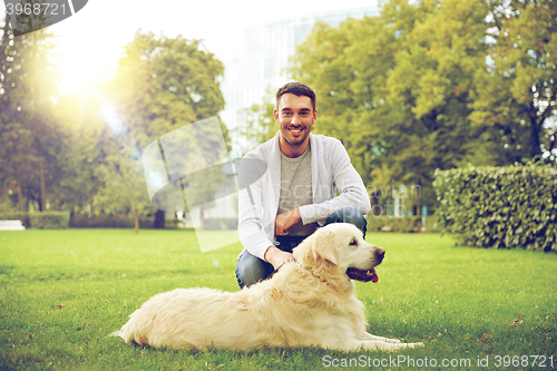 Image of happy man with labrador dog walking in city