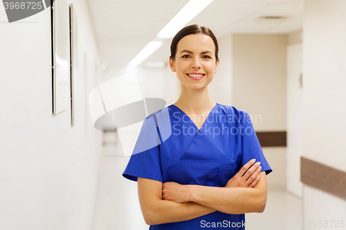 Image of happy doctor or nurse at hospital corridor