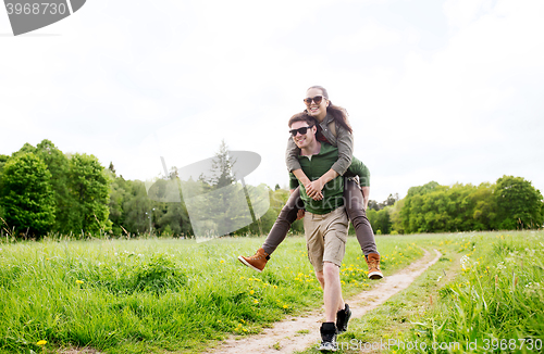 Image of happy couple with backpacks having fun outdoors