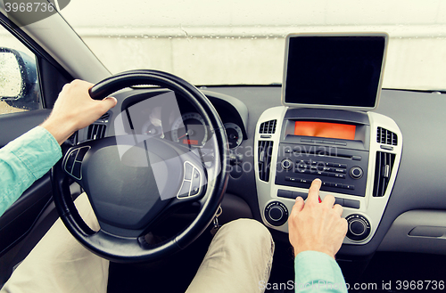 Image of close up of young man with tablet pc driving car