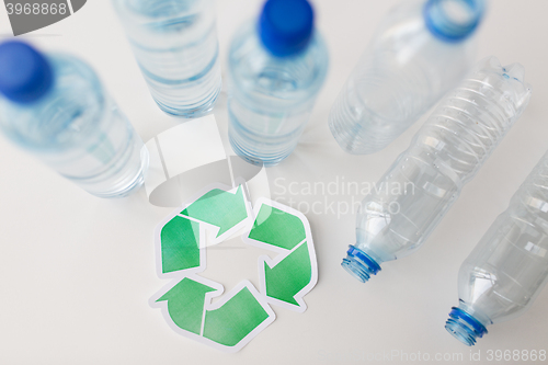 Image of close up of plastic bottles and recycling symbol