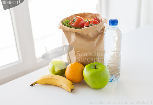 Image of basket of vegetable food and water at kitchen