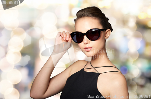 Image of beautiful young woman in elegant black sunglasses