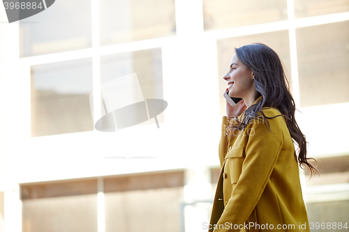 Image of smiling young woman or girl calling on smartphone