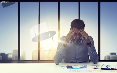 Image of close up of anxious businessman with papers