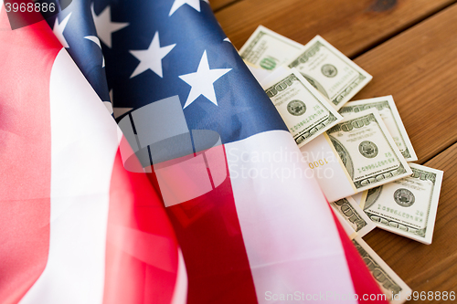 Image of close up of american flag and dollar cash money