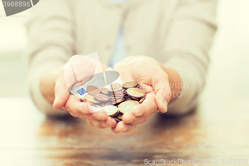 Image of close up of senior woman hands holding money