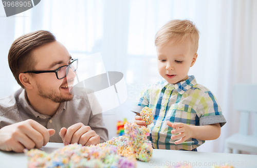 Image of father and son playing with ball clay at home