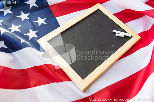 Image of close up of school blackboard on american flag