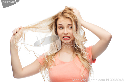 Image of woman holding strand of her hair