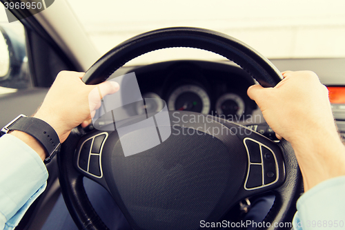 Image of close up of young man driving car