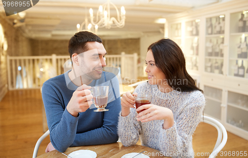 Image of happy couple drinking tea at cafe