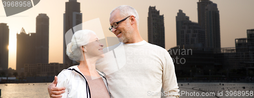 Image of senior couple over dubai city street background