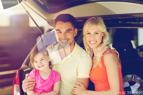 Image of happy family with hatchback car at home parking