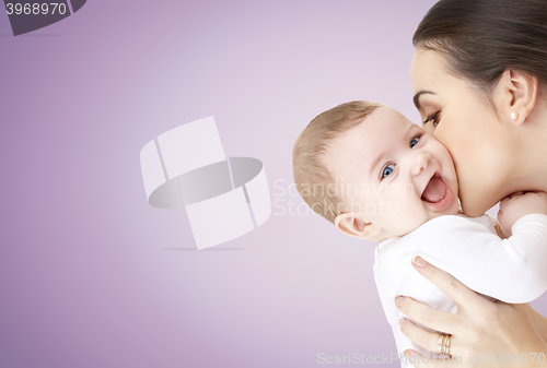 Image of happy mother kissing adorable baby