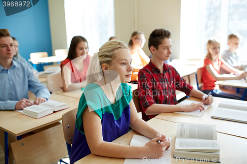 Image of group of students with books at school lesson