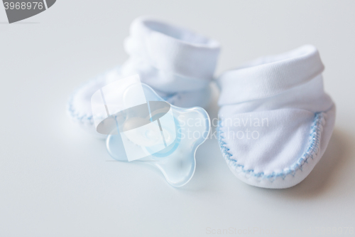 Image of close up of baby bootees and soother for newborn