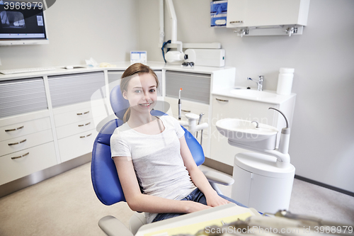 Image of happy patient girl at dental clinic office