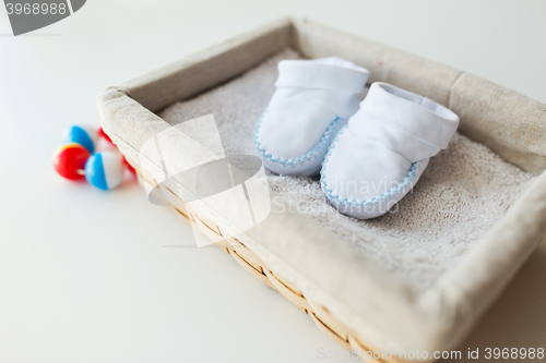 Image of close up of baby bootees for newborn boy in basket