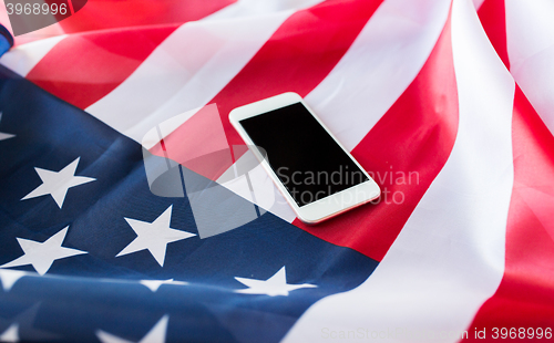 Image of close up of smartphone on american flag